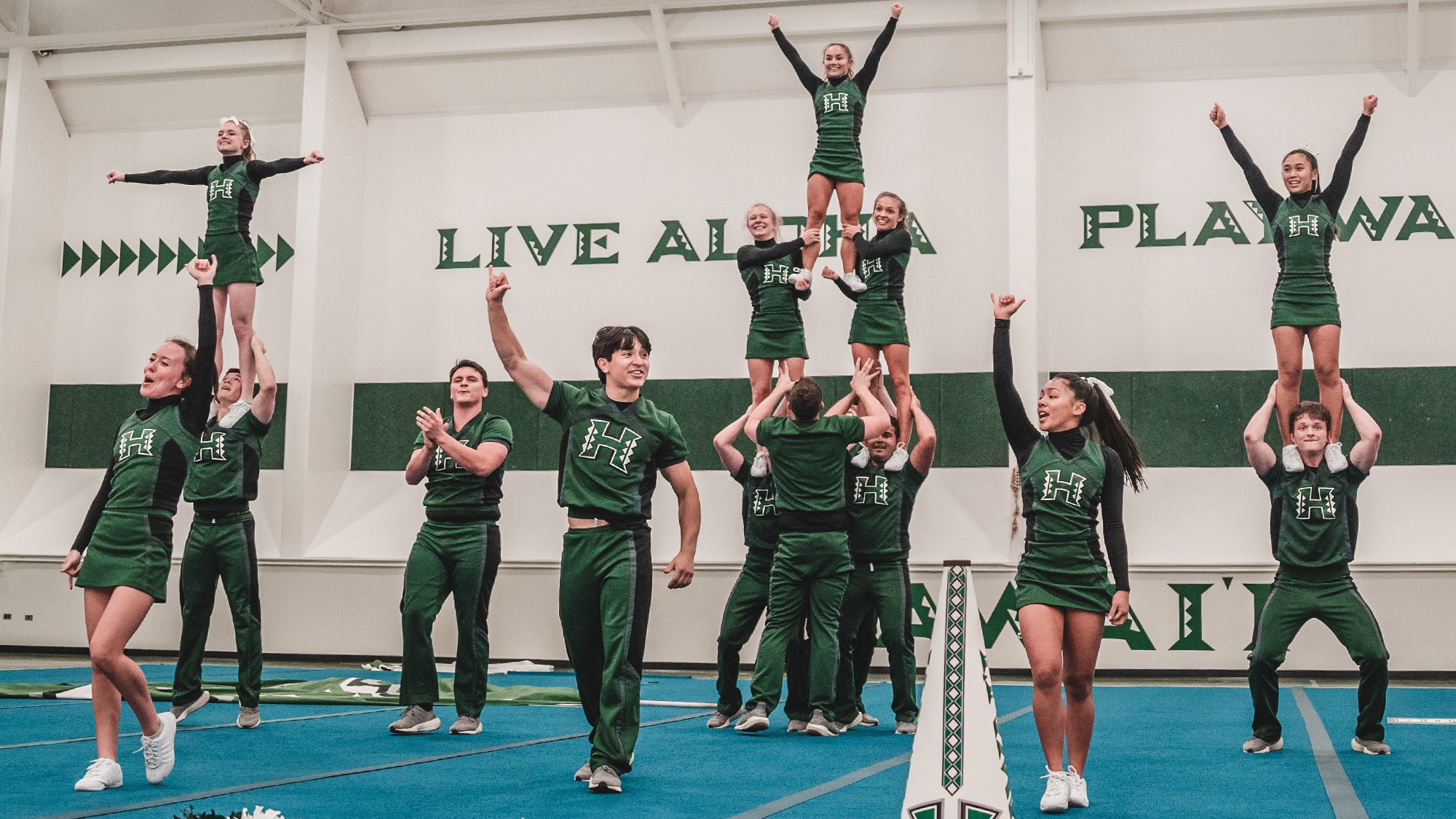 University of Hawaii cheerleaders performing at a competition showing the high level of athleticism and skill in Hawaii collegiate cheerleading