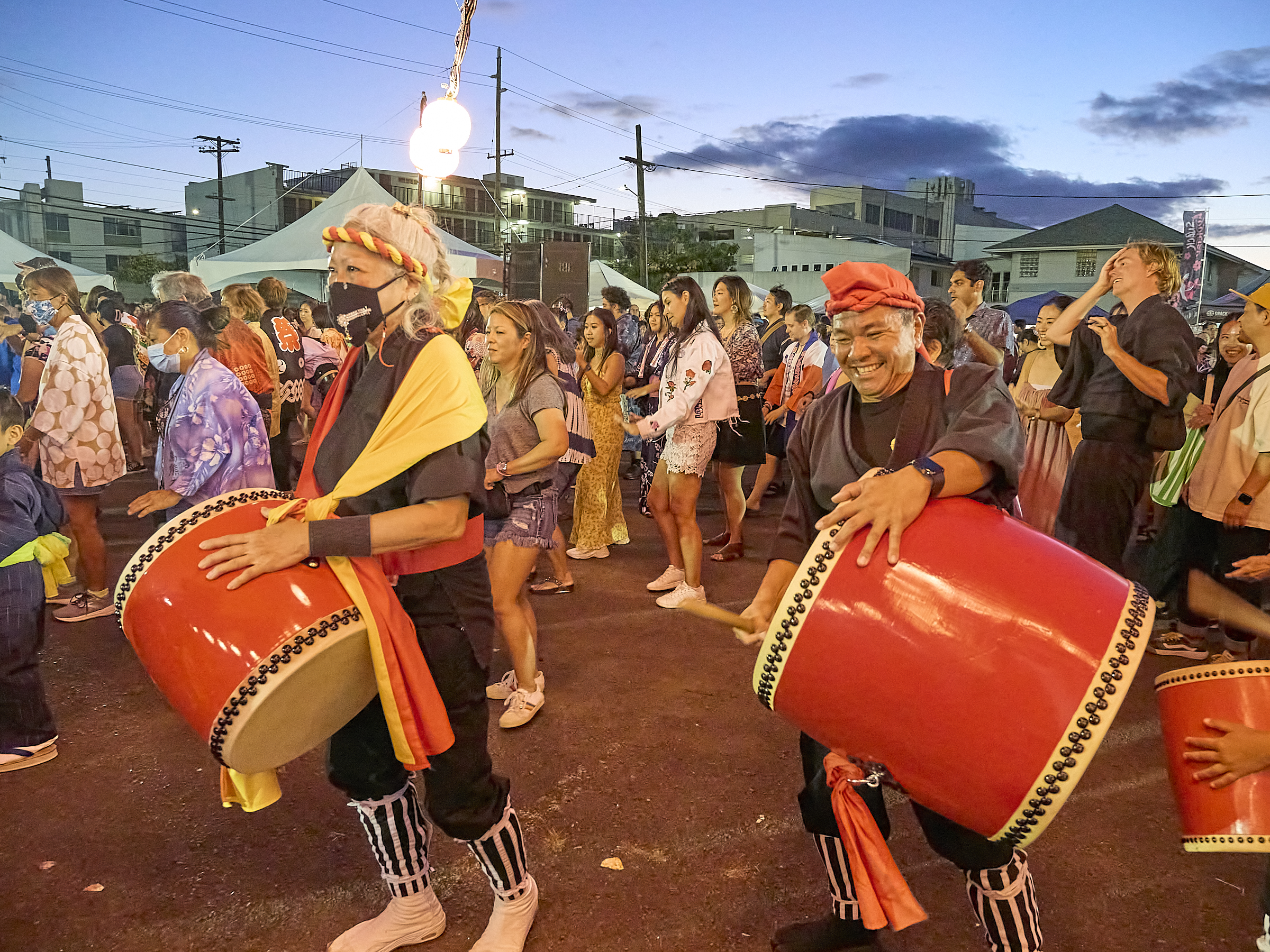 Okinawan community members performing traditional music and dance at a Hawaii cultural event representing community engagement and performance